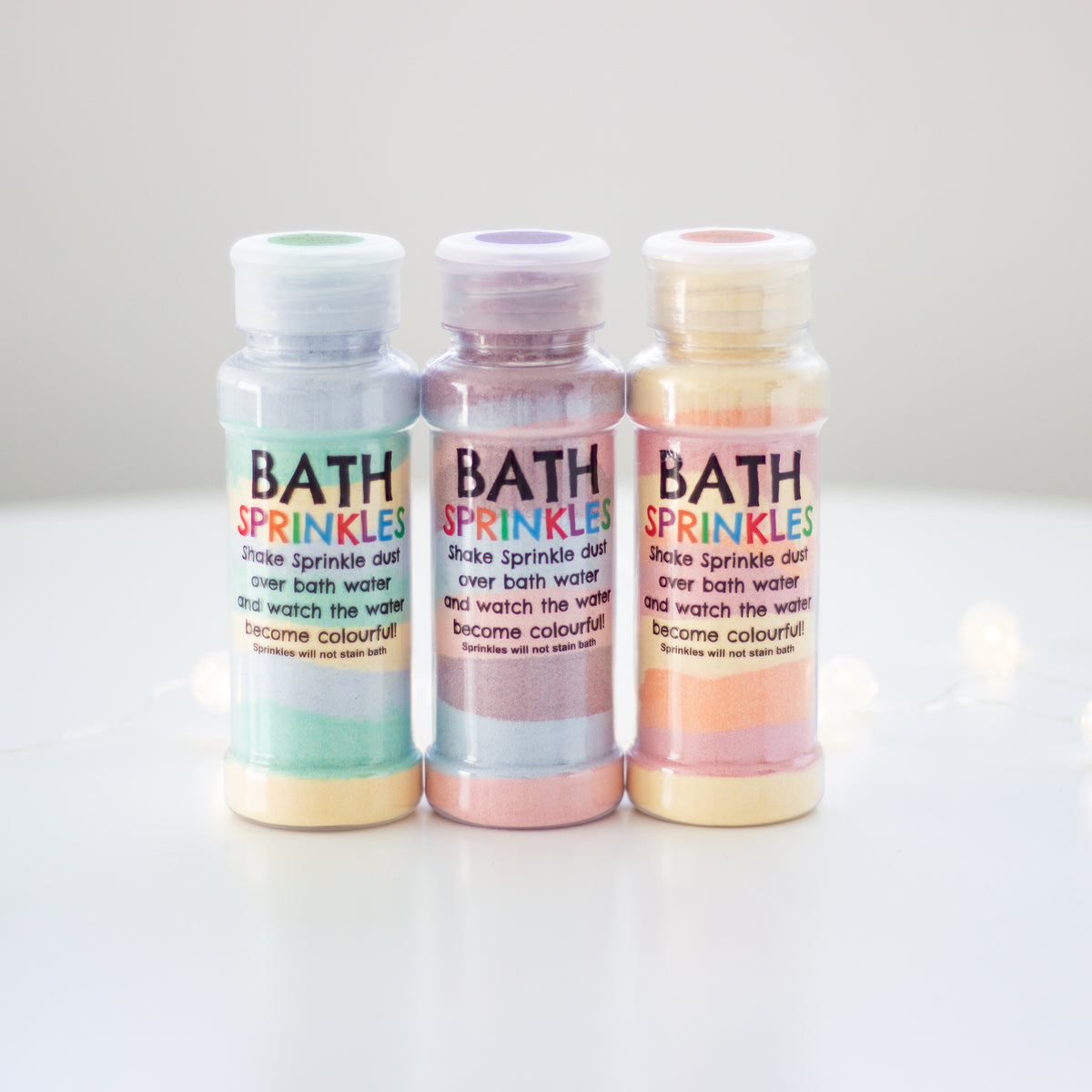 Bath Sprinkles shakers in purple, orange and green