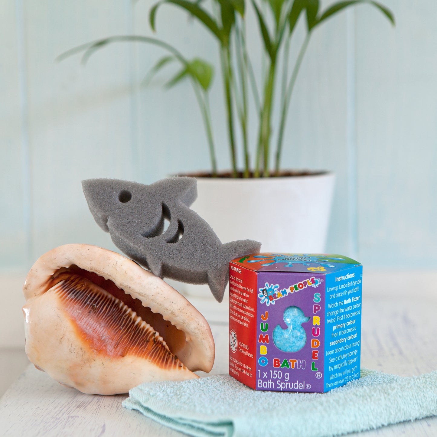 Blue Jumbo Bath Bomb Sprudel in its box with a shark sponge toy