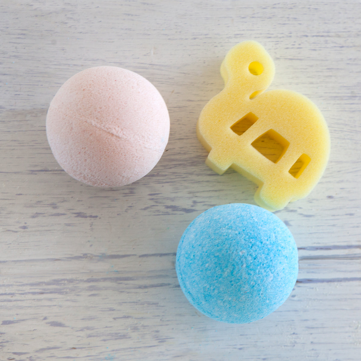 Pink and blue Jumbo Bath Bomb Sprudels with a tortoise sponge toy