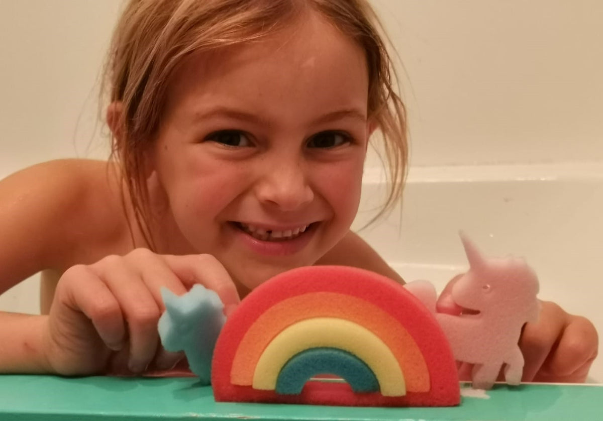 Girl in the bath with Unicorn Rainbow Bath Beans